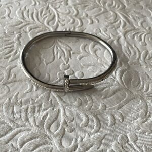 Costume silver nail bracelet, with rhinestones with one stone missing